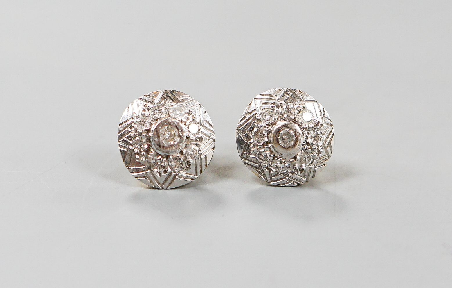 A pair of 18k yellow and white metal, diamond chip set circular ear studs, 12mm, gross weight 5.6 grams.